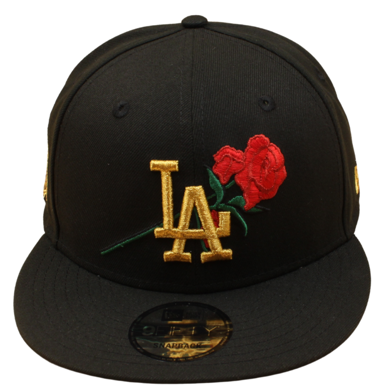Sort New Era 9FIFTY snapback cap med Los Angeles Dodgers 40-års jubilæumslogo i rosegulv, 9FIFTY stil, afslappet og moderne.