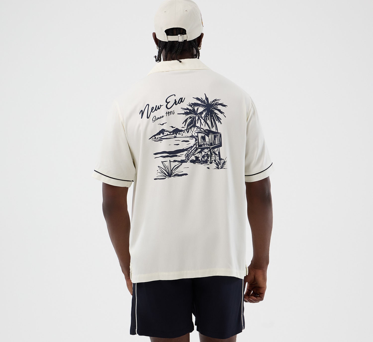 Off-white New Era T-shirt med grafisk design og New Era logo, afslappet og stilfuldt til hverdag.