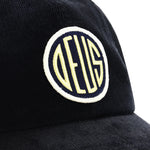 DEUS Pill Cord Trucker cap i sort med neonfarvet logo og netpanel relaterede corddetaljer