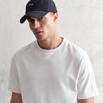 Navy Spencer sport cap fra Wax London med bomuld, afslappet stil, synlig i et klart billede.