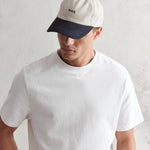 Mænds navy og stenfarvet bomuldssports cap fra Wax London med justerbar rem og komfortabel pasform.